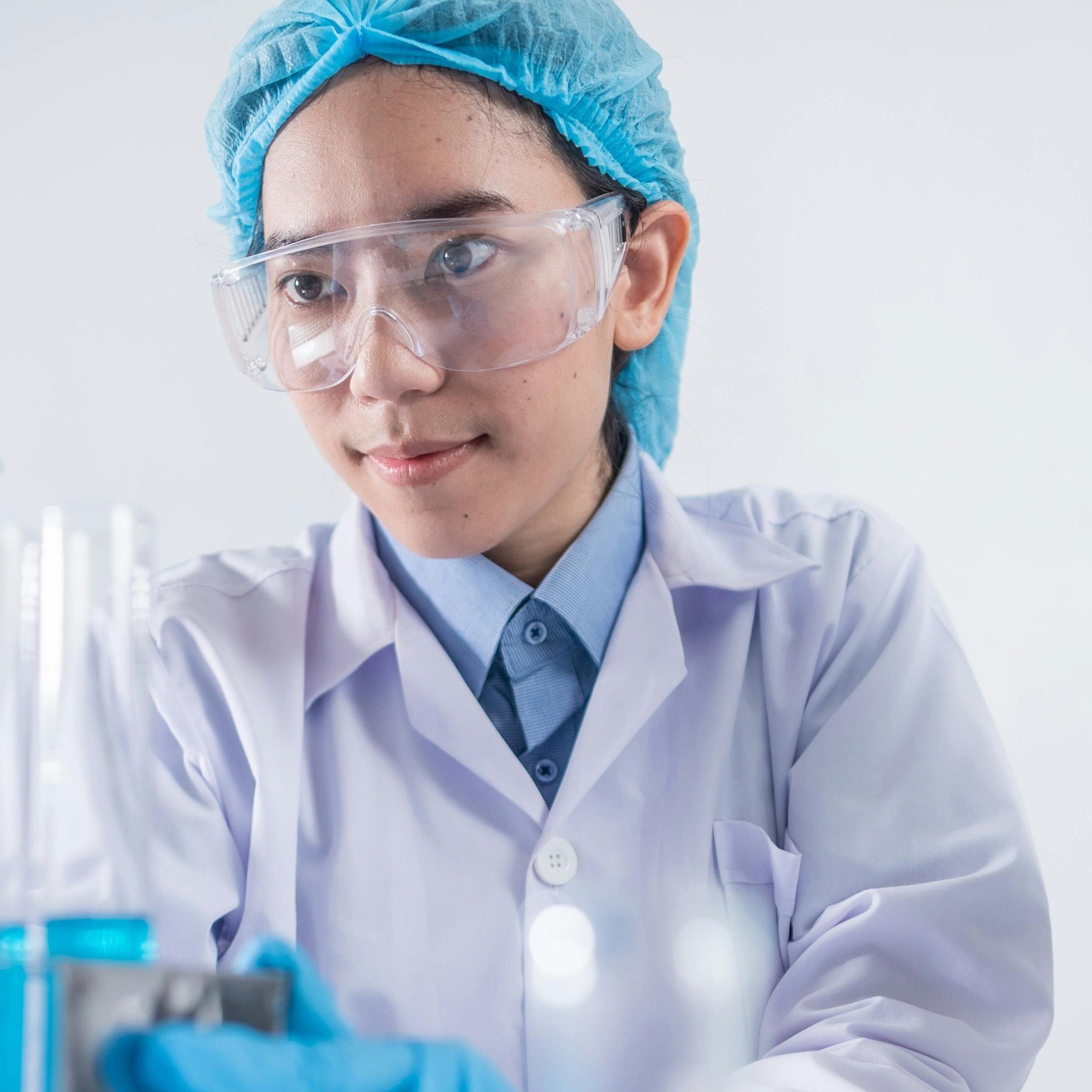A female scientist using lab equipment for research in a modern laboratory setting.